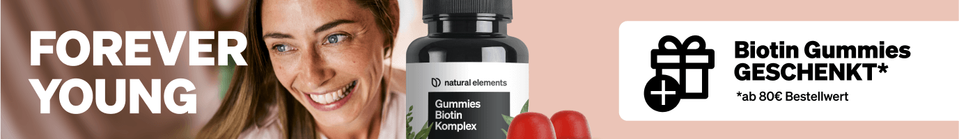 Lächelnde Frau neben einer Flasche Biotin-Gummis; der Text lautet "FOREVER YOUNG" und wirbt für ein kostenloses Geschenk bei einem Einkauf über 80 €.